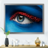 DesignArt 'žensko oči s plavom bojom na licu i crvenim kuglicama' moderni uokvireni umjetnički tisak